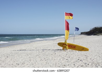 Australian Beach Surf Rescue Surfboard And Flags On Bribie Island Beach, Queensland, Australia