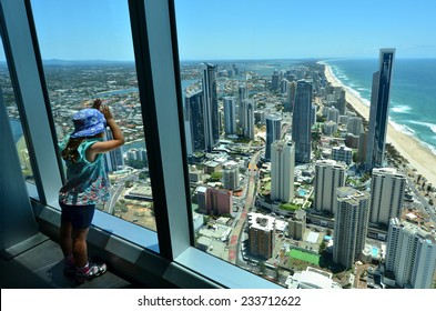 Australian child (girl age 04) looks at aerial landscape view of Surfers Paradise from Skypoint observation deck at the top of the Q1 Tower in Surfers Paradise Gold Coast Queensland, Australia.