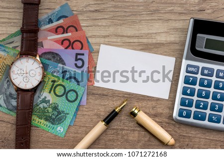 Australian dollar with business card, pen and calculator
