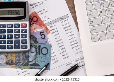 australian dollar with graph, home budget laptop and calculator