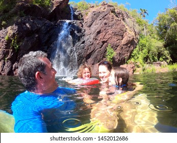 Australian Family (four People ) Having Fun At  Wangi Falls In Litchfield National Park In The Northern Territory Australia. Real People. Copy Space