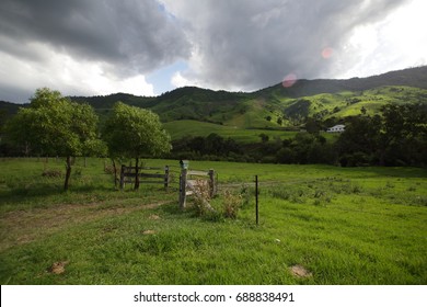 Australian Farm Gate With Rolling Hills And Cloudy Sky