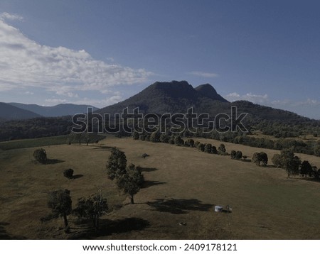 Australian farmland with mountin in the background. 