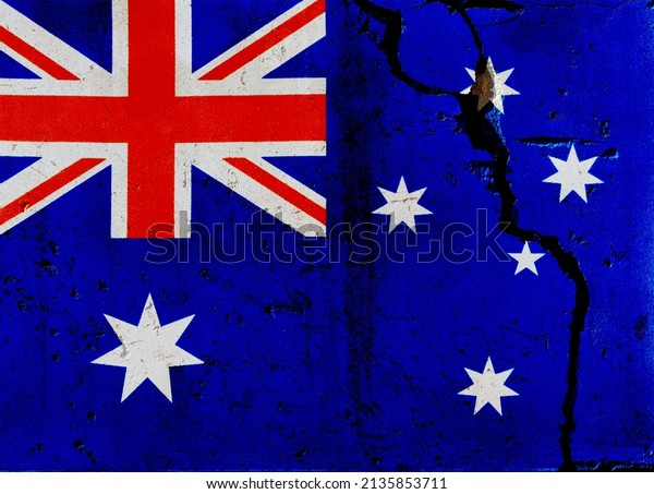 Australian flag on cracked\
wall.