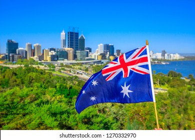 Australian Flag Waving Aver Perth Water, A Section Of Swan River, And Central Business District Of Perth From Kings Park, The Most Popular Visitor Destination In WA. Blue Sky. Perth Skyline Aerial