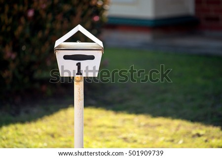 Australian home letterbox with number one on frontyard