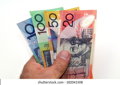 Australian man holding Australian Dollar bank notes. Concept photo of money, banking ,currency and foreign exchange rates.  Isolated on white background. Copy space