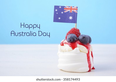 Australian mini pavlova and flag in red, white and blue for Australia Day or national holiday party food treats, and sample text. 