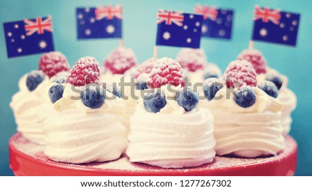 Australian mini pavlovas and flags in red, white and blue for Australia Day or national holiday party food treats, with applied vintage wash filter.