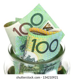 Australian money in jar, over white background.  One hundred dollar bills.
