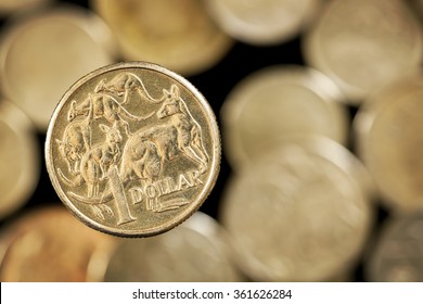 Australian One Dollar Coin Over Blurred Golden Background.