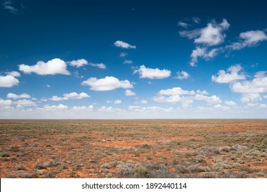 The Australian Outback With A Crescent Moon In The Sky.