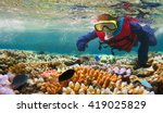 Australian person snorkeling scuba diving with life jacket vest and Lycra protection suit at the Great Barrier Reef in the tropical far north of Queensland, Australia. Real people. Copy space