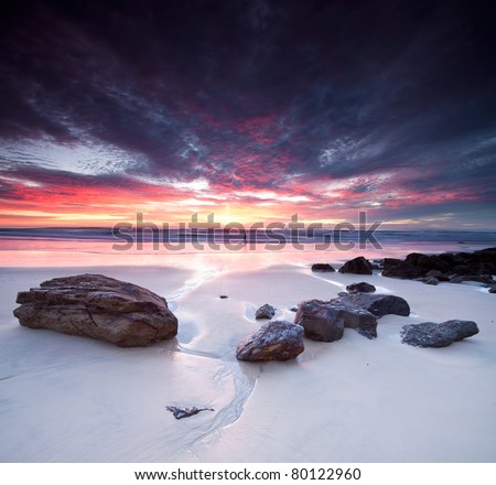 Similar – Image, Stock Photo Sunset, stone beach with small and large rocks in front of the illuminated sea
