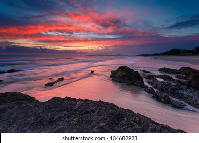 australian seascape at sunrise with rich in red color cloud formation (currumbin beach,queensland,australia)