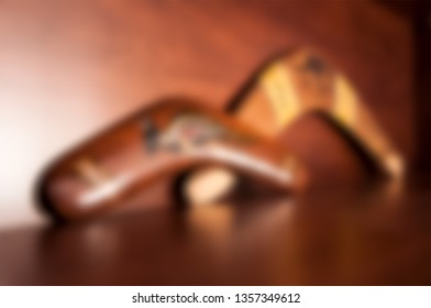 Australian Souvenirs, Boomerangs On Wooden Shelf. Blurred Photo For Background.