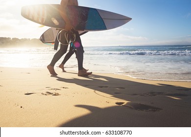 Australian surfers walking along Bondi Beach in the early morning for a surf - Powered by Shutterstock