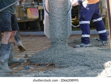 Australian tradesmen with concrete mixer truck pouring concrete