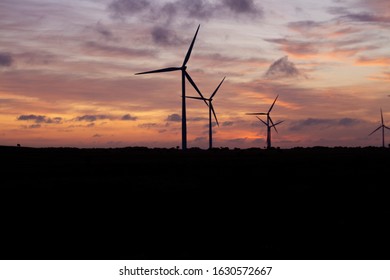 An Australian wind farm with a vibrant sunset due to the smoke haze from the Bush fires 2020. 