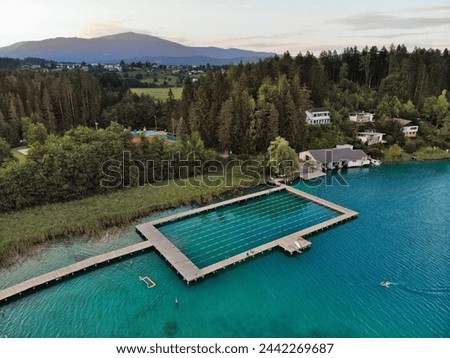 Austria drone view. Natural swimming pool on Lake Faak (Faaker See) in Carinthia state.