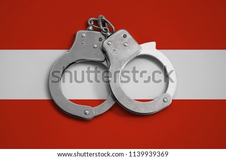 Austria flag  and police handcuffs. The concept of observance of the law in the country and protection from crime