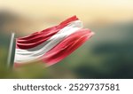 Austria flag waving with beautiful background. The flag blowing with green blur background. Austria national flag for independence day.