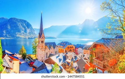 Austria, Hallstatt Historical Village. UNESCO World Heritage Site, Old European Architecture In Sunlight. Hallstatter See In Background. Hallstatt Is Iconic World Landmark. Autumn Seasonal Landscape.