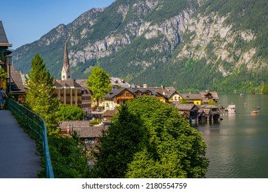 Austria, Hallstatt Historical Village. UNESCO World Heritage Site, Old European Architecture In Sunlight. Hallstatter See In Background. Hallstatt Is Iconic World Landmark.