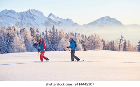 Austria, tyrol, couple snowshoeing stock photo - Powered by Shutterstock