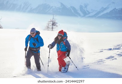 Austria- tyrol- snowshoe hikers running through snow - Powered by Shutterstock