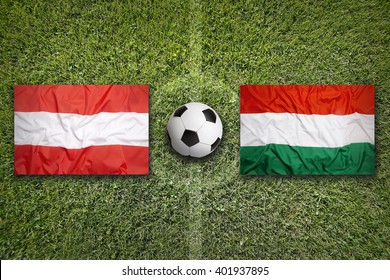 Austria Vs. Hungary Flags On Green Soccer Field