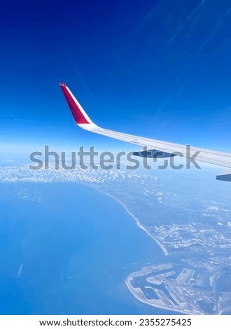 Austrian airlines flying over Europoort, Netherlands