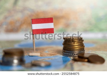 austrian flag on map with stacked coins in the foreground, symbolizing austria's economy, financial growth, banking sector, investments, and trade opportunities