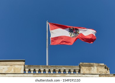 Austrian flag waving against blue sky