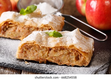 Austrian food: apple strudel with powdered sugar and mint closeup on the table. Horizontal - Shutterstock ID 668254558