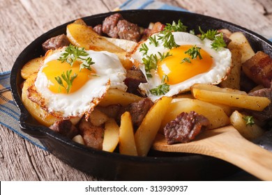 Austrian Food: Fried Potatoes With Meat, Ham And Eggs In A Pan Close-up. Horizontal
