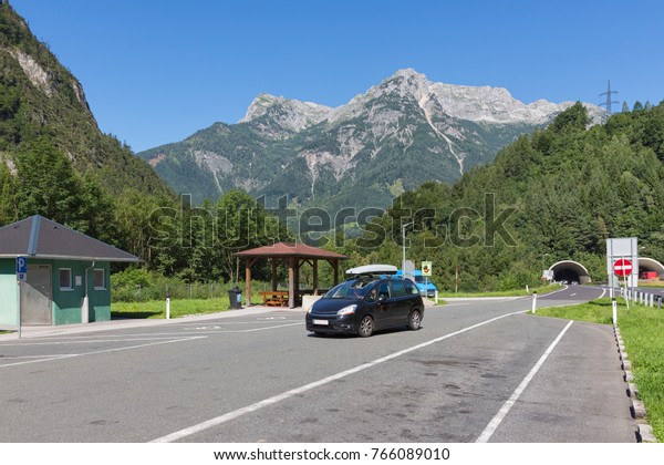 Austrian highway A10 with\
car park near Hohenwerfen with traffic leaving a tunnel through the\
mountains