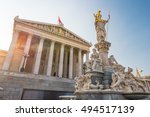 Austrian parliament building with Athena statue on the front in Vienna, Austria. Beautiful travel picture with sunset light.