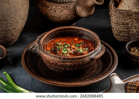 Authentic beef stew with vegetables and herbs served in a rustic clay pot, surrounded by bread and pottery, ideal for traditional cuisine, cultural dining, and comfort food concepts.
