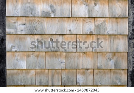 Authentic cedar shingle wall background evokes traditional wood house charm. Textured, natural, and weathered, ideal for rustic architecture.