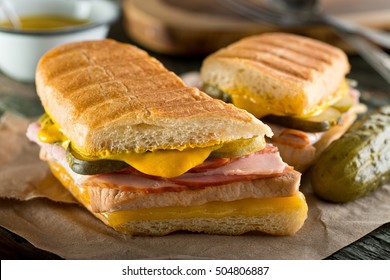 An Authentic Cuban Sandwich On Pressed Medianoche Bread With Pork, Ham, Cheese, Pickle, And Mustard.