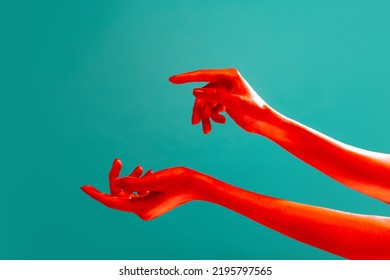 Authentic hands gesturing isolated on cyan color background in red neon light. Concept of relationship, community, care, support, symbolism, culture. Copy space for ad - Powered by Shutterstock