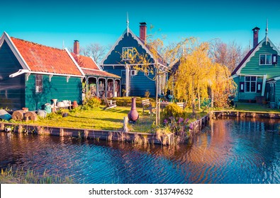 Authentic Holland architecture on the water channel in Zaanstad village. Zaanse Schans Windmills and famous Netherlands canals, Europe. Instagram toning.