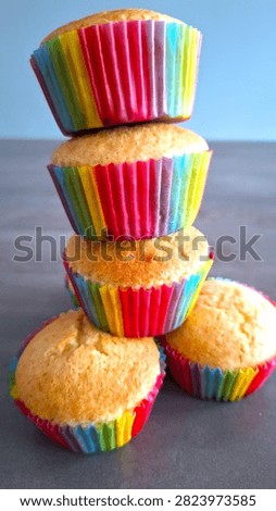 Authentic, imperfect rustic-looking cupcakes featuring vibrant rainbow layers and cracked surfaces, symbolizing real home baking for Pride Month. Close-up of basic, easy-to-make rainbow celebration cupcakes with naturally cracked tops, perfect for casual cooking blunders, love, and diversity themes. Quick and easy homemade rainbow cupcakes with a basic, rustic look on a table, baked to celebrate Gay Pride week and LGBTQ+ love.