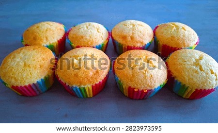 Authentic, imperfect rustic-looking cupcakes featuring vibrant rainbow layers and cracked surfaces, symbolizing real home baking for Pride Month. Close-up of basic, easy-to-make rainbow celebration cupcakes with naturally cracked tops, perfect for casual cooking blunders, love, and diversity themes.  