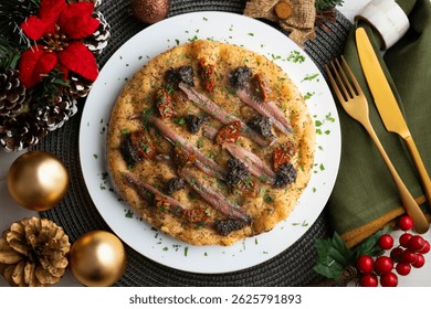 Authentic Italian focaccia with salted anchovies, sun-dried tomatoes, and black olives. Top view table with christmas decorations.