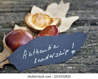 Authentic Leadership - Chestnut On Wooden Background With Note