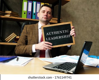 Authentic Leadership Concept. Young Businessman Holds A Black Board.