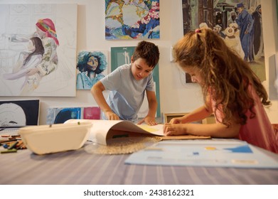 Authentic lifestyle portrait of kids painting and drawing in the visual art class in art school or gallery with displayed artworks on the wall. Kids entertainment and artistic education concept - Powered by Shutterstock