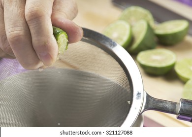 Authentic male hand squeezing citrus hystrix and lime ingredient for further homemade food cooking